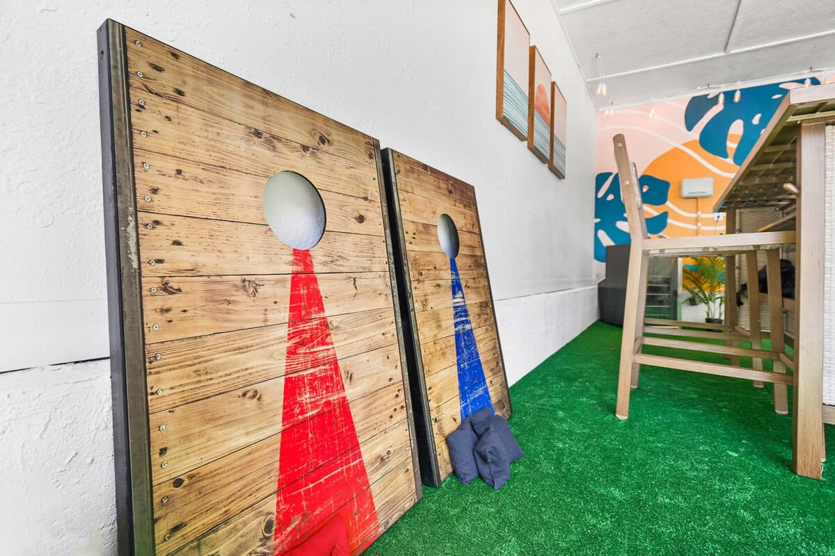 Cornhole boards leaning against the lounge wall, ready to be carried out onto the grass. Every group has one person who takes this far too seriously, and by day three you will know exactly who yours is.