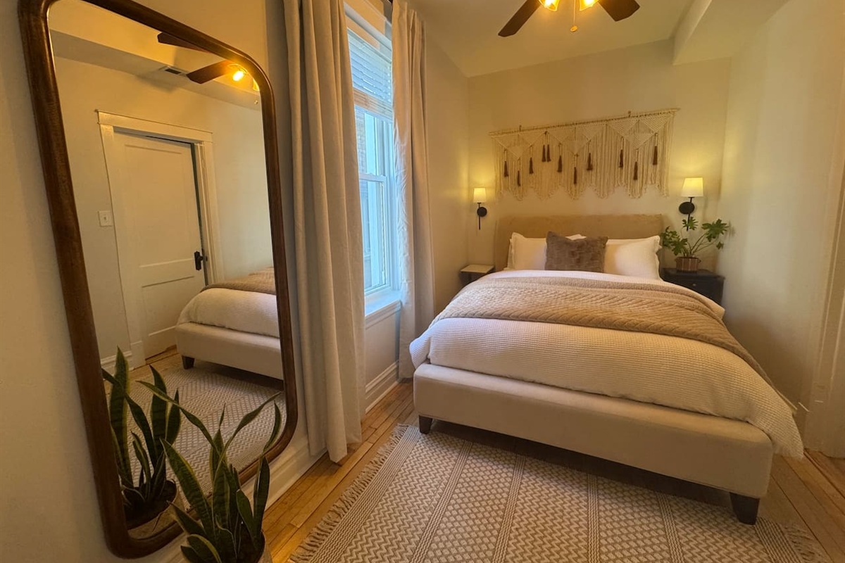 Bright bedroom with cozy design and comfortable mattress.