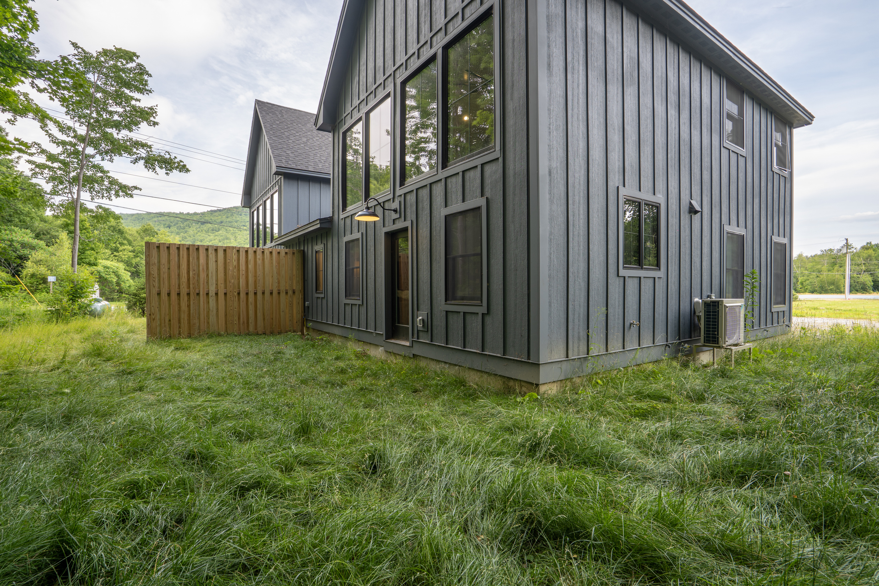 A peaceful grassy outdoor space surrounded by trees and fresh mountain air.