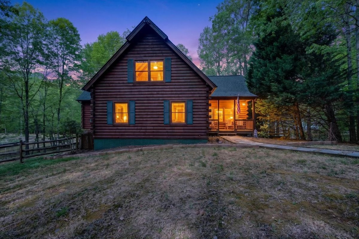 Stunning log cabin with lake views and cozy glow.