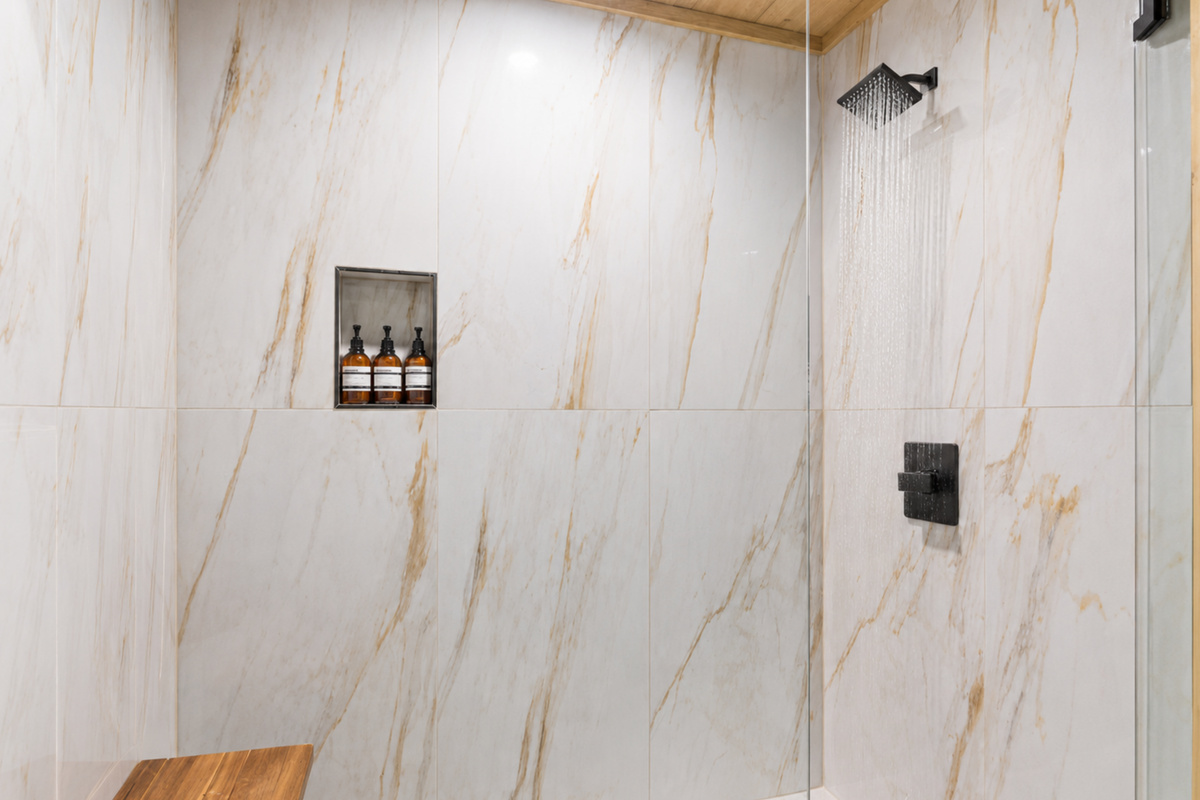 Sophisticated touches meet spa-level serenity in this marble-style shower built for true relaxation.