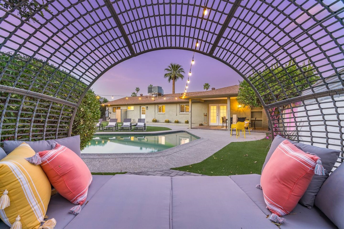 DREAM BACK YARD features large pool with Baja step; covered patio with dining table; putting green; gas fire pit;  sun loungers; Giant Jenga; and corn hole.Pool can be heated for an add'l fee.