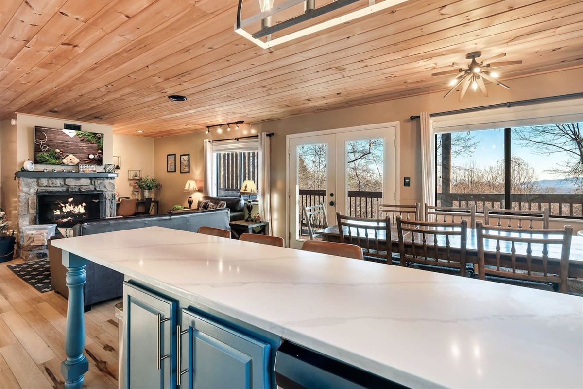 The main floor kitchen, dining area, living area, and deck with seasonal views, BBQ grill and private hot tub.