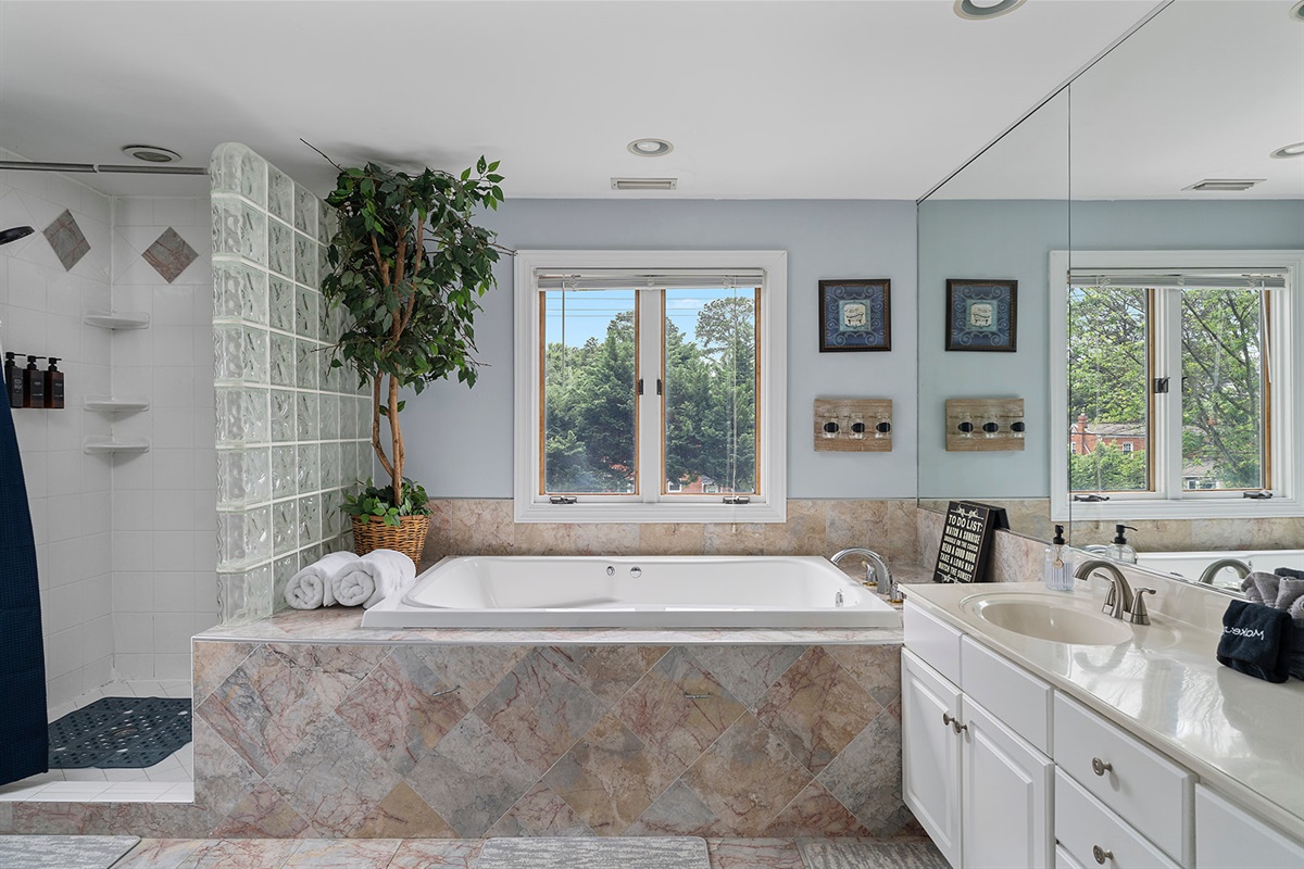 Master Bathroom 1: Indulge in relaxation with a soaking jacuzzi/tub and nature views!