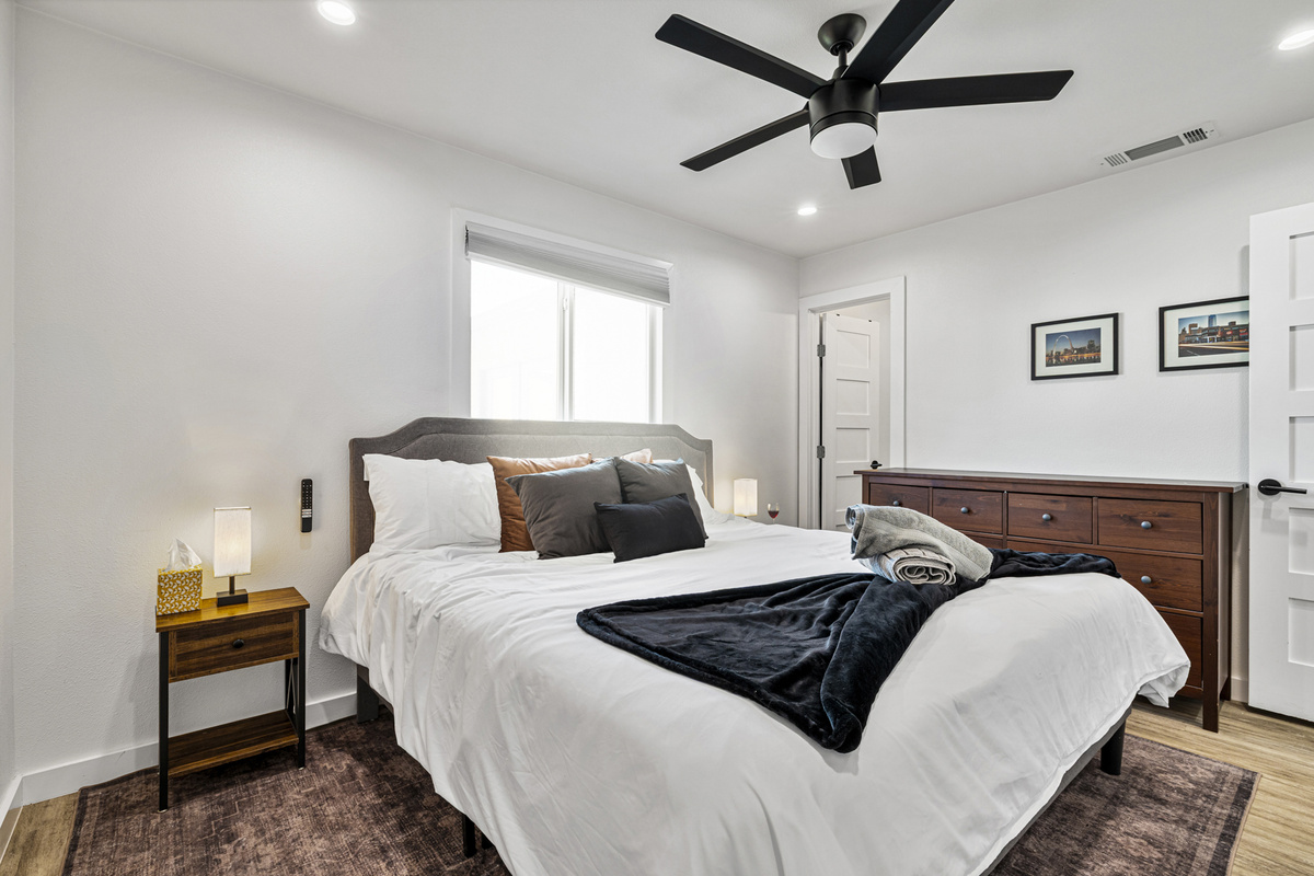 Relax in this bright haven with plush bedding and stylish decor!