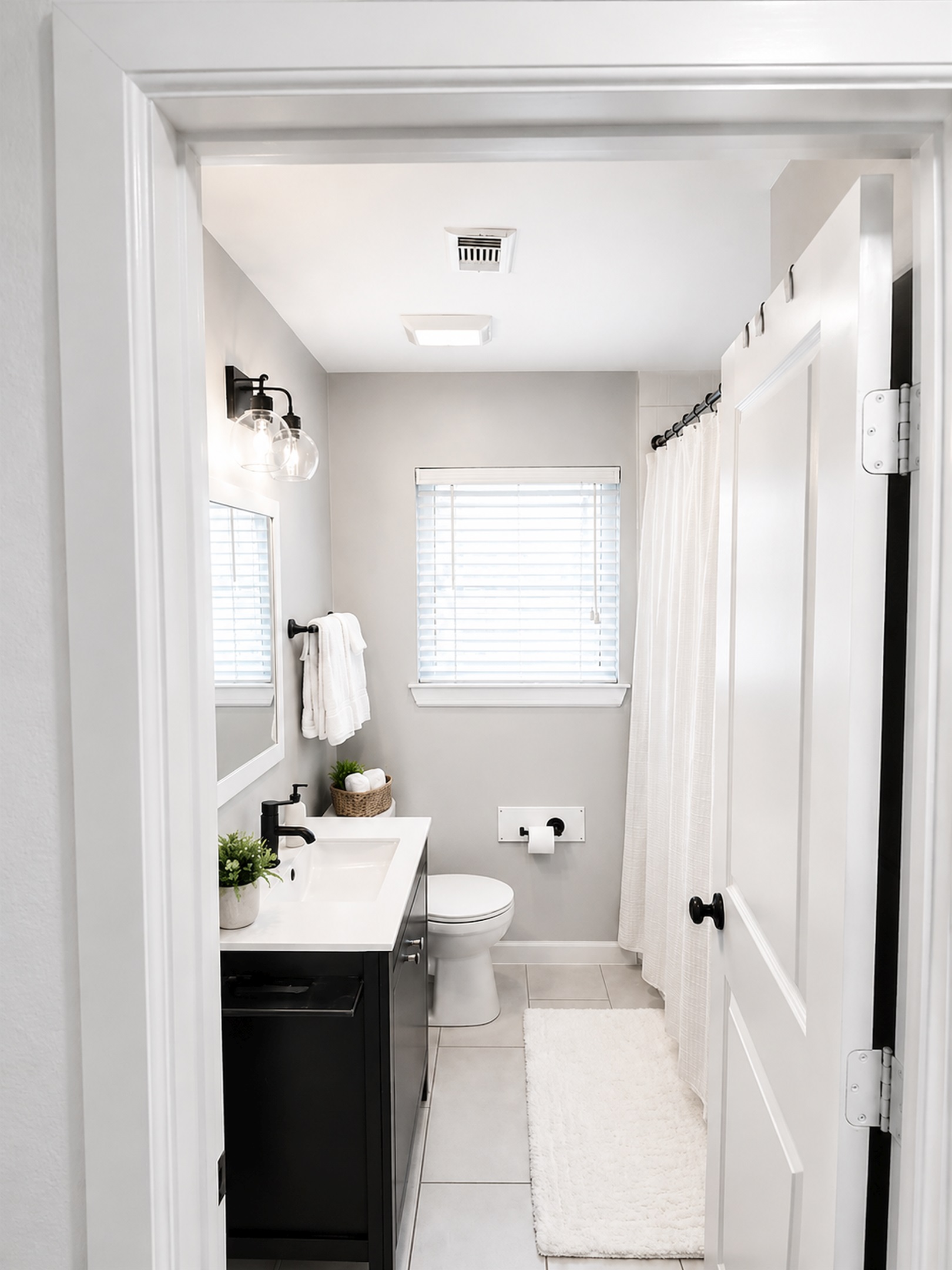 Clean and airy full bathroom with soaking tub, modern vanity, and fresh boutique-hotel aesthetic