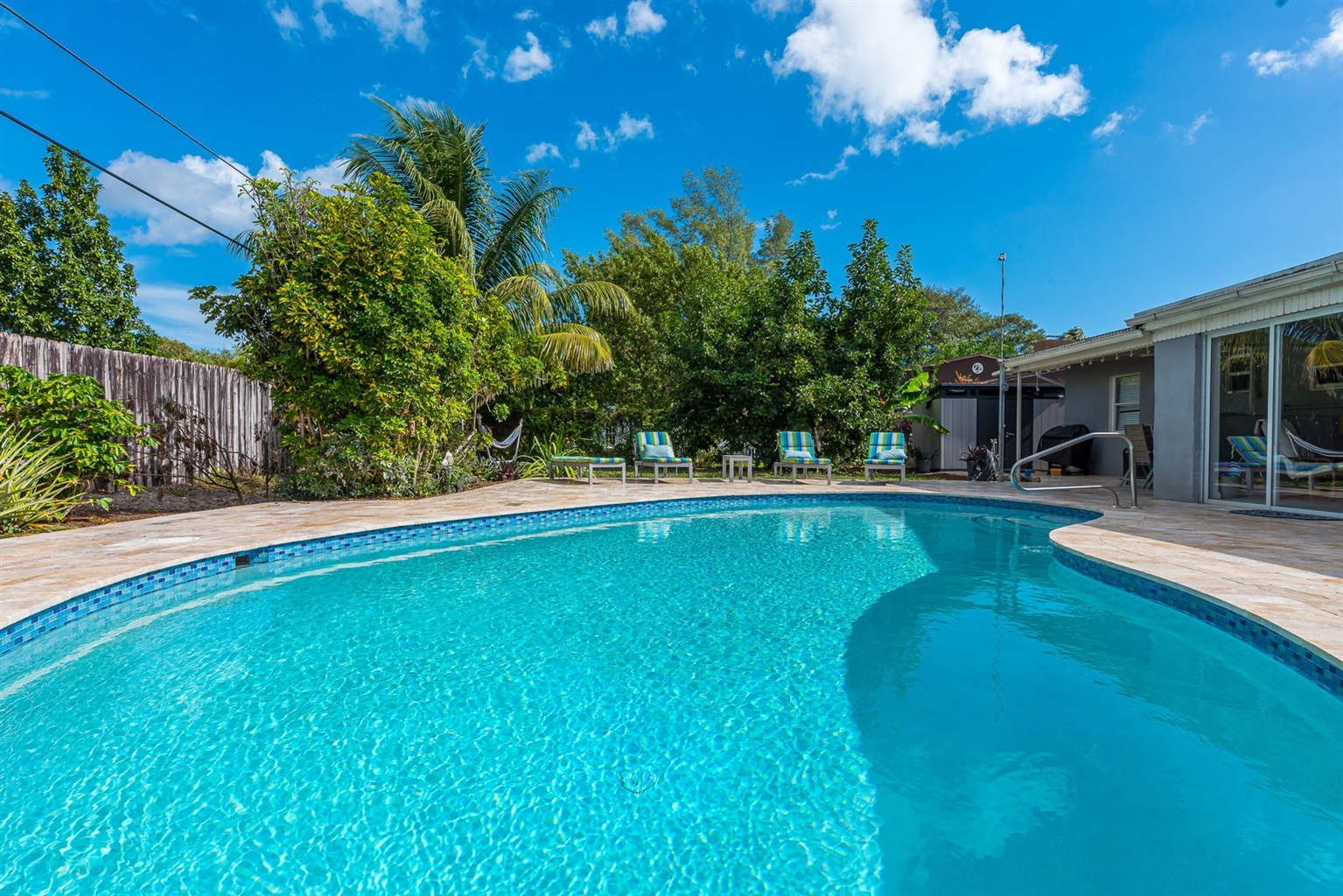 The outside is a highlight, with the heated pool, outdoor sun- loungers, BBQ and covered dining area.