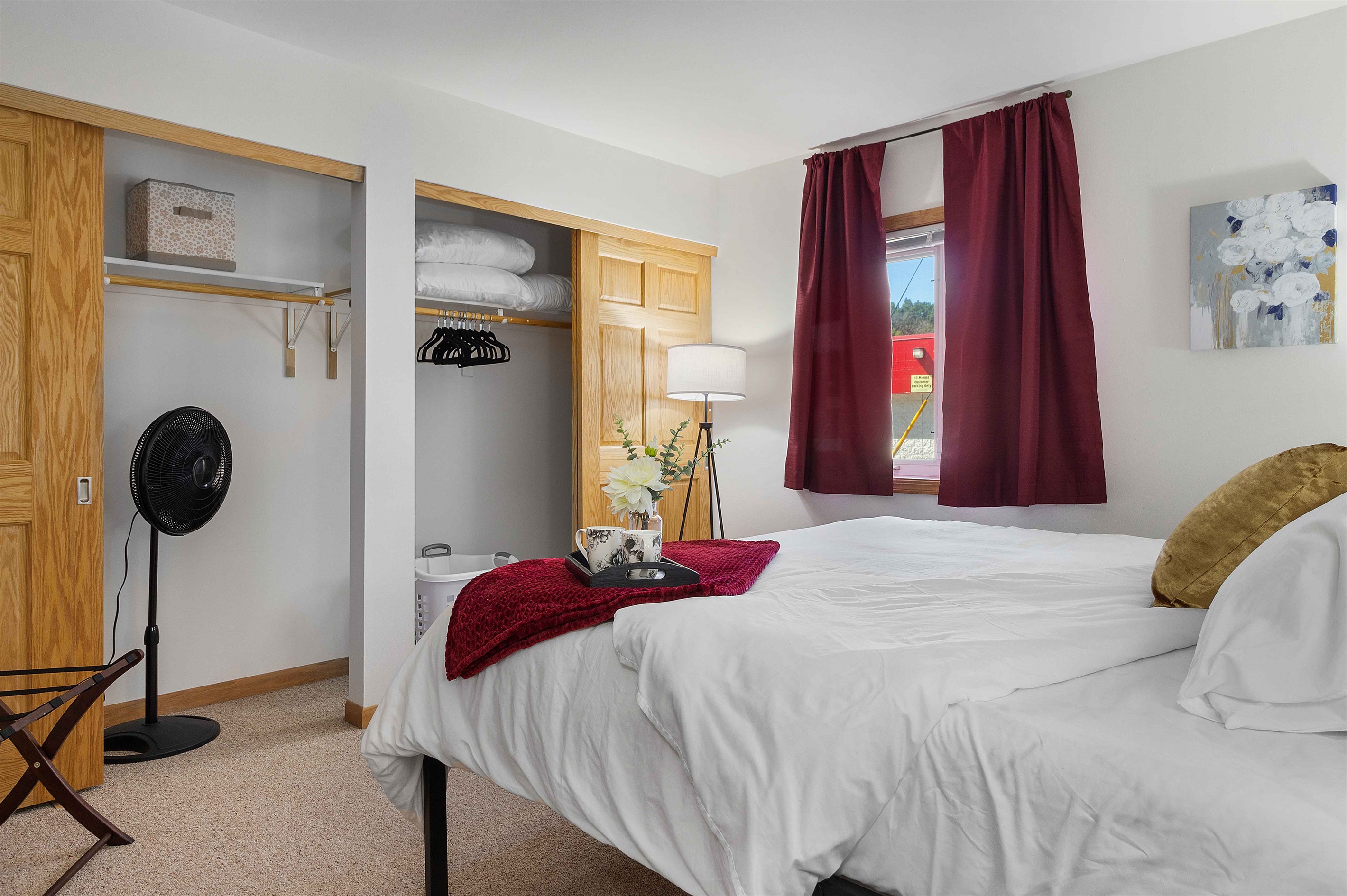 Luggage rack and velvet hangers in ample bedroom closet space. Extra queen bedding for the pullout couch is here in the bedroom closet.