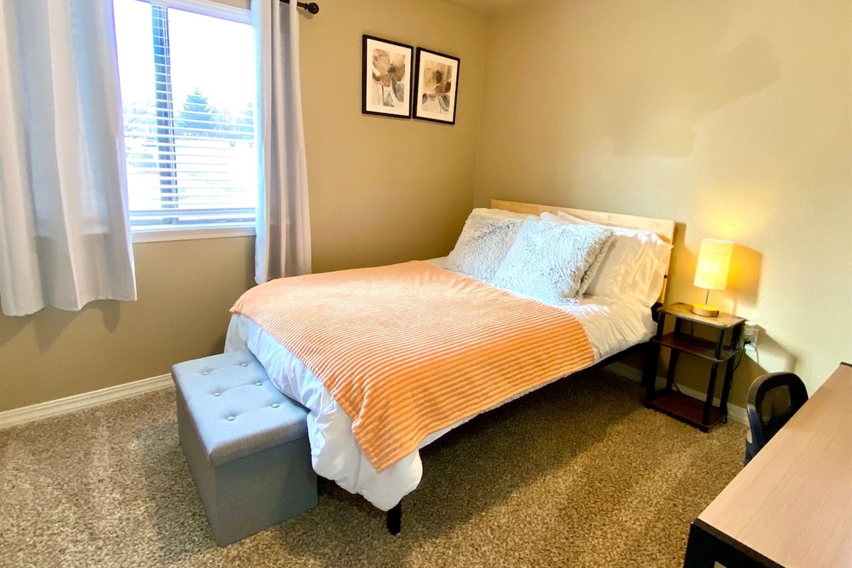 Bedroom with double bed and desk