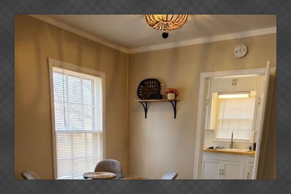 Stylish dining area with a modern round table, plush seating, and a statement light fixture—perfect for meals or gathering with friends.