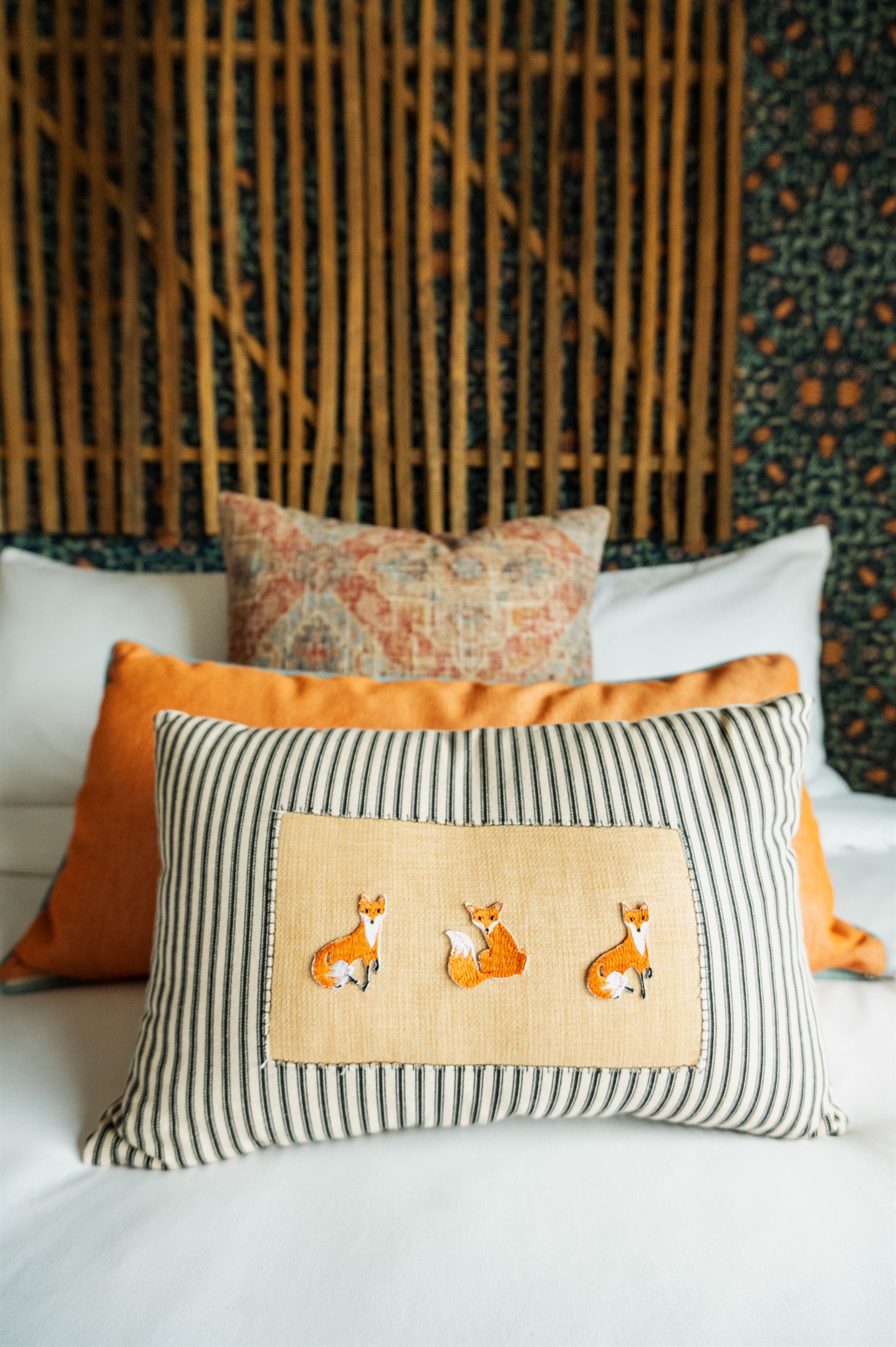  Curated textile detail at the Corral Suite — handcrafted accent pillows layered over premium Comphy linens at Gaines Ranch on the Square.