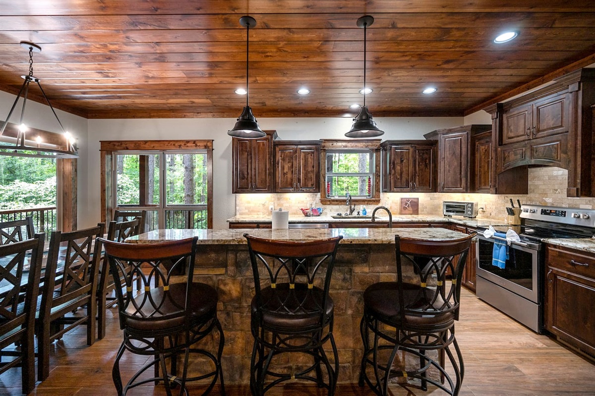 Fully equipped kitchen is conveniently located directly off of the living room