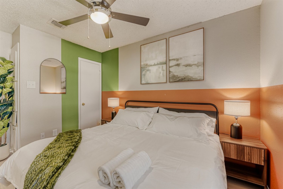 Modern bedroom with bold color accents and a cozy, inviting atmosphere.