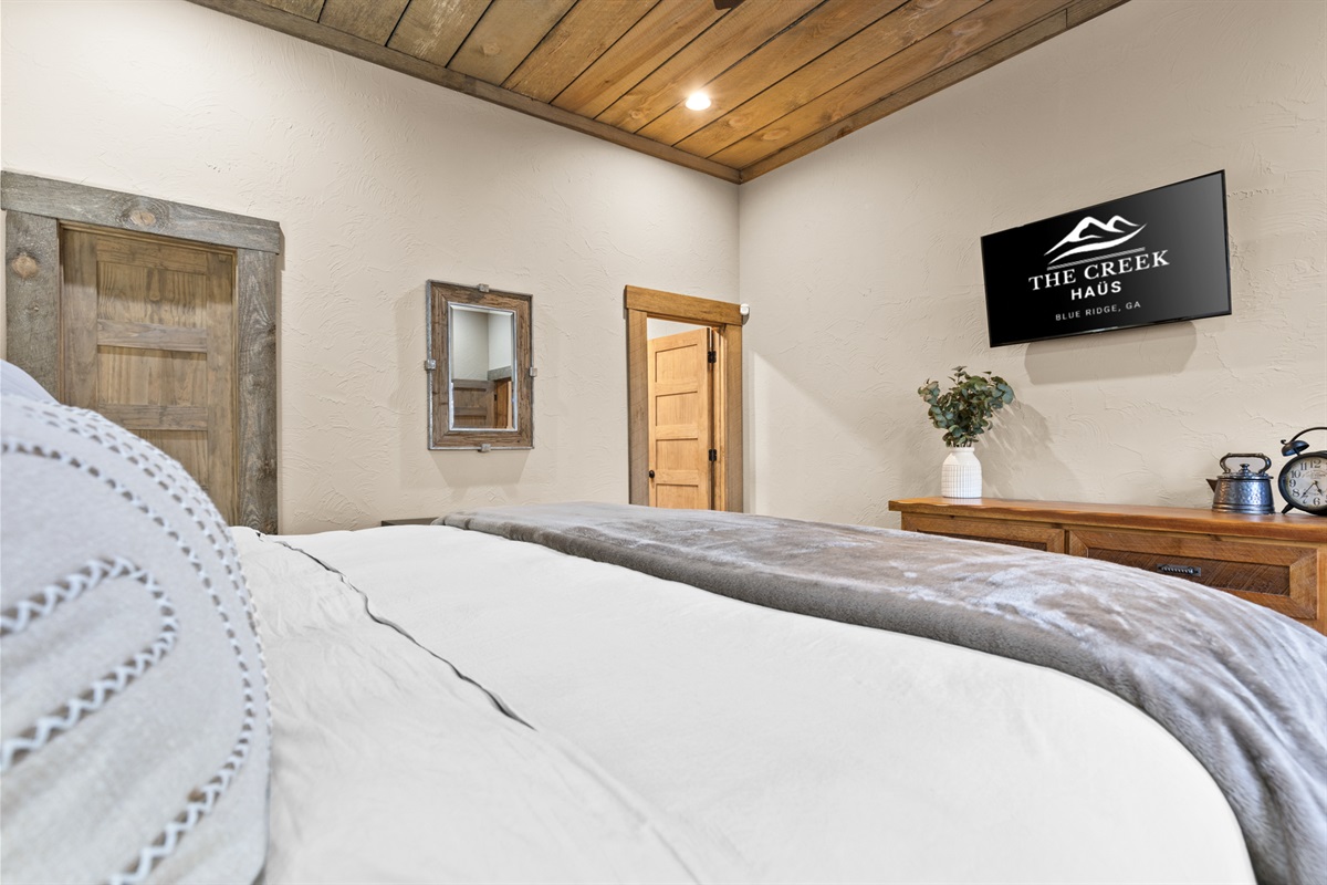 A cozy rustic bedroom with warm wood accents, soft textiles, and charming details that create a peaceful, inviting retreat.