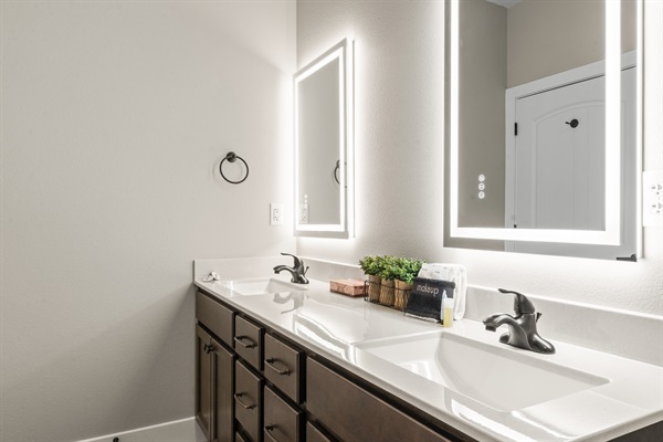 Master Bathroom #2 has his and her sinks with lighted mirrors to get ready for a night on the town. The mirrors also have an anti-fog feature.