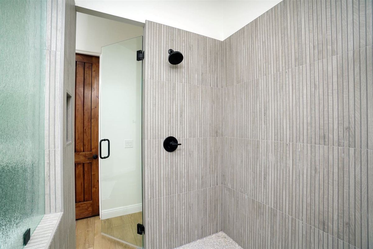 Owner's suite shower, with opposing dual shower heads on either side for a shared experience.