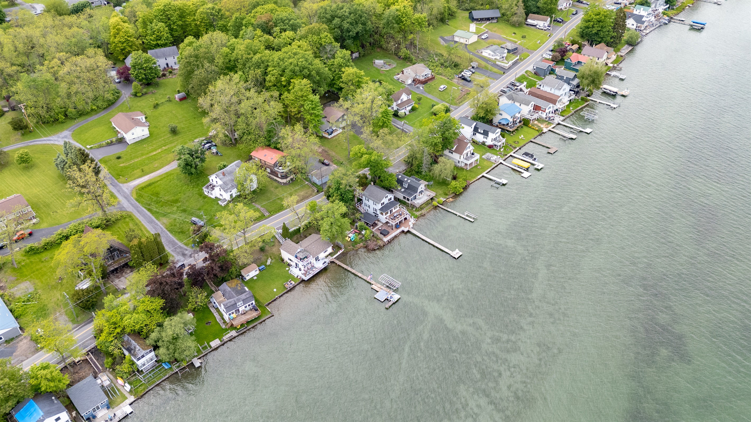 Aerial shot showcasing expansive lakefront entertaining space, hot tub, and private dock for the ultimate getaway 🎯🌊🍹