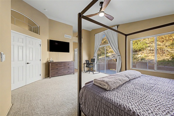 Primary Suite: Bright retreat with king bed, ensuite bathroom, walk in closet, 55" TV, remote workstation and stunning mountain views from your private deck!