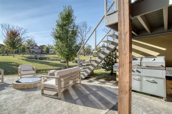 Lower Level outdoor area with fire pit, gas grill and hot tub.