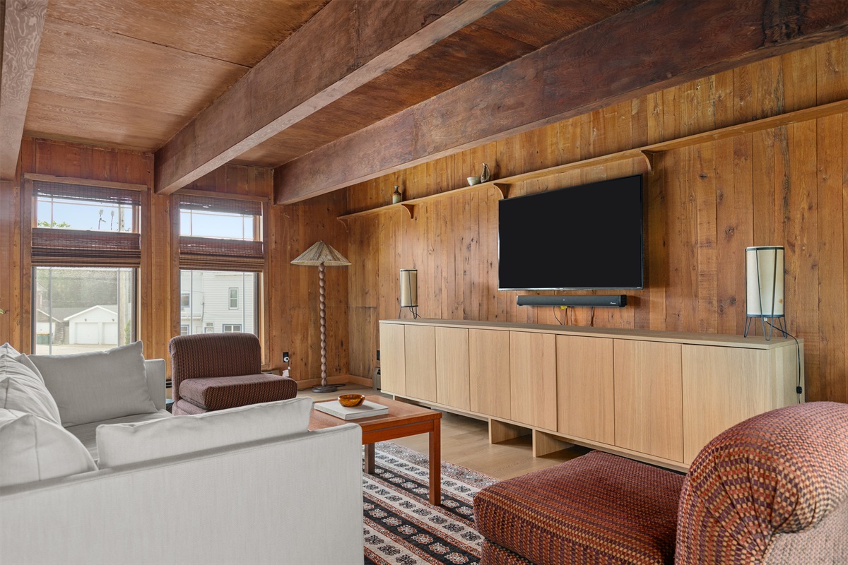 The primary bedroom invites you to relax with your own private seating area. Curl up on the sofa or settle into one of the two modern chairs, the perfect spot to unwind with a show or enjoy a quiet moment awa