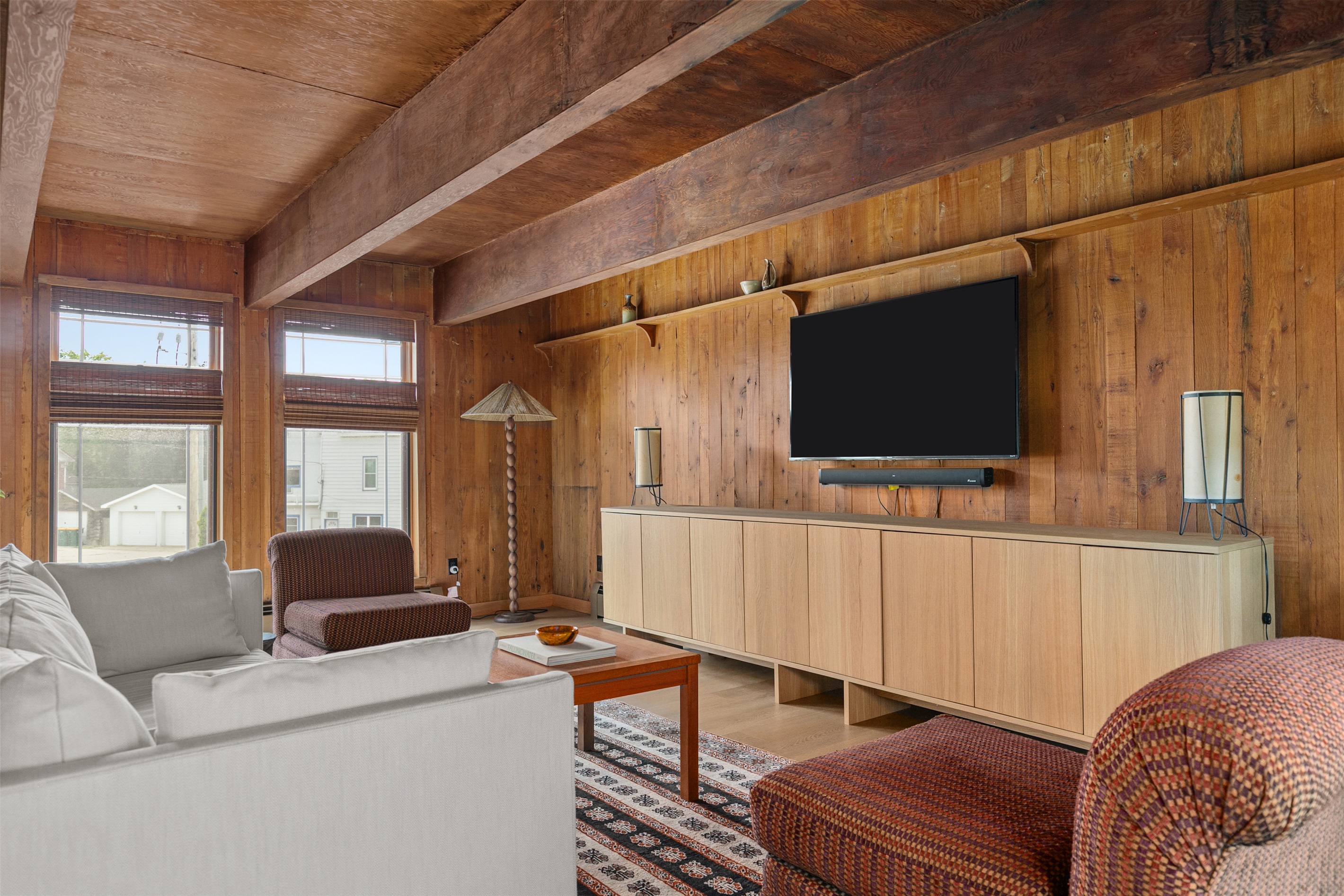 The primary bedroom invites you to relax with your own private seating area. Curl up on the sofa or settle into one of the two modern chairs, the perfect spot to unwind with a show or enjoy a quiet moment awa