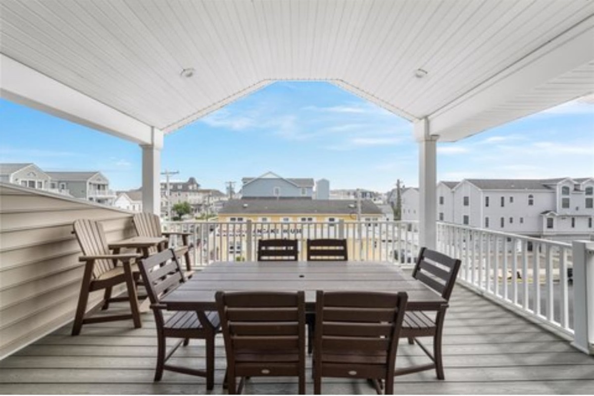 Private covered deck for dining and entertaining off the main living room on the top floor with spectacular ocean views. 