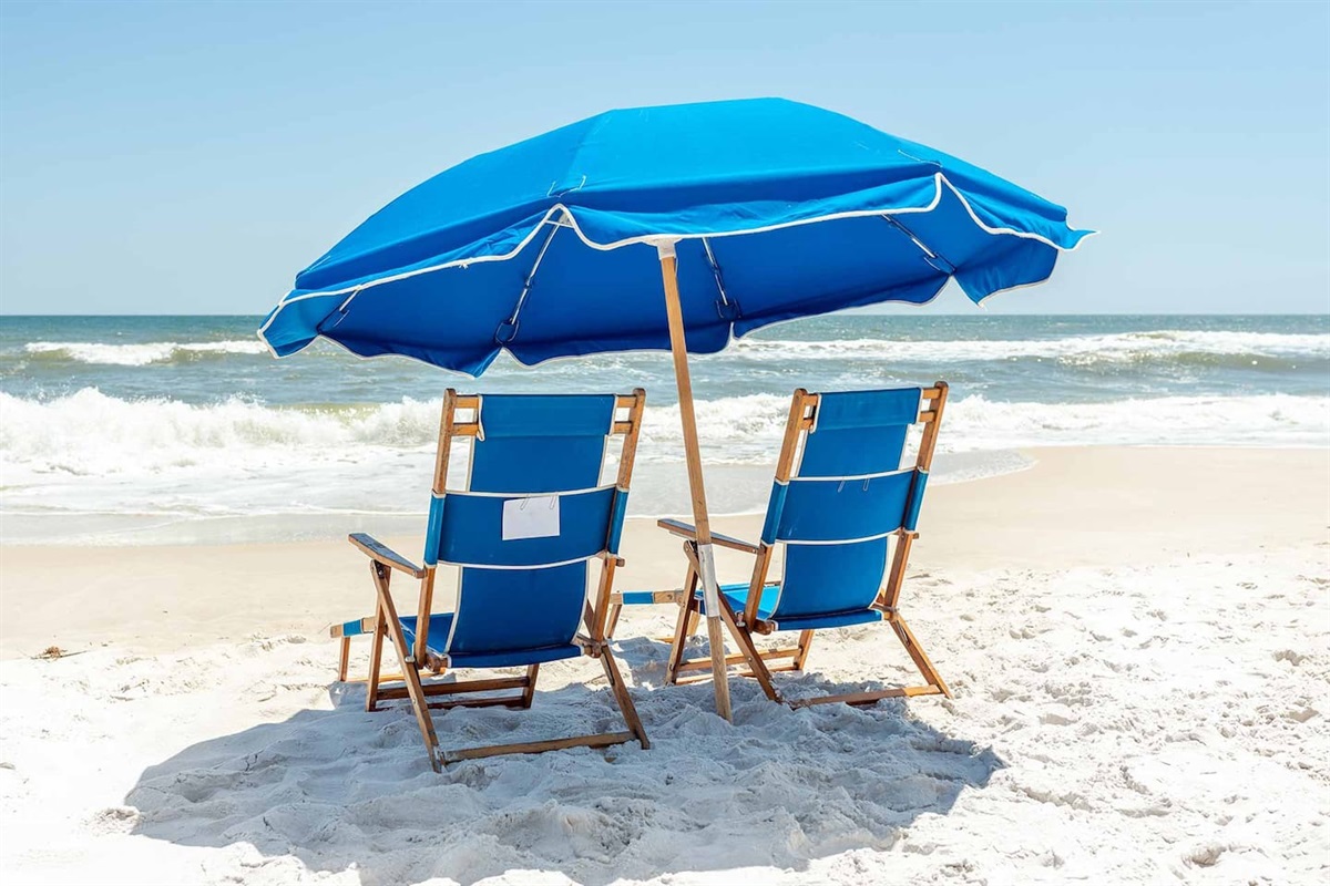 Beach Bliss: Relax under a vibrant umbrella, soaking in the sun and ocean views! Just a 5 minute drive to white sandy beaches!