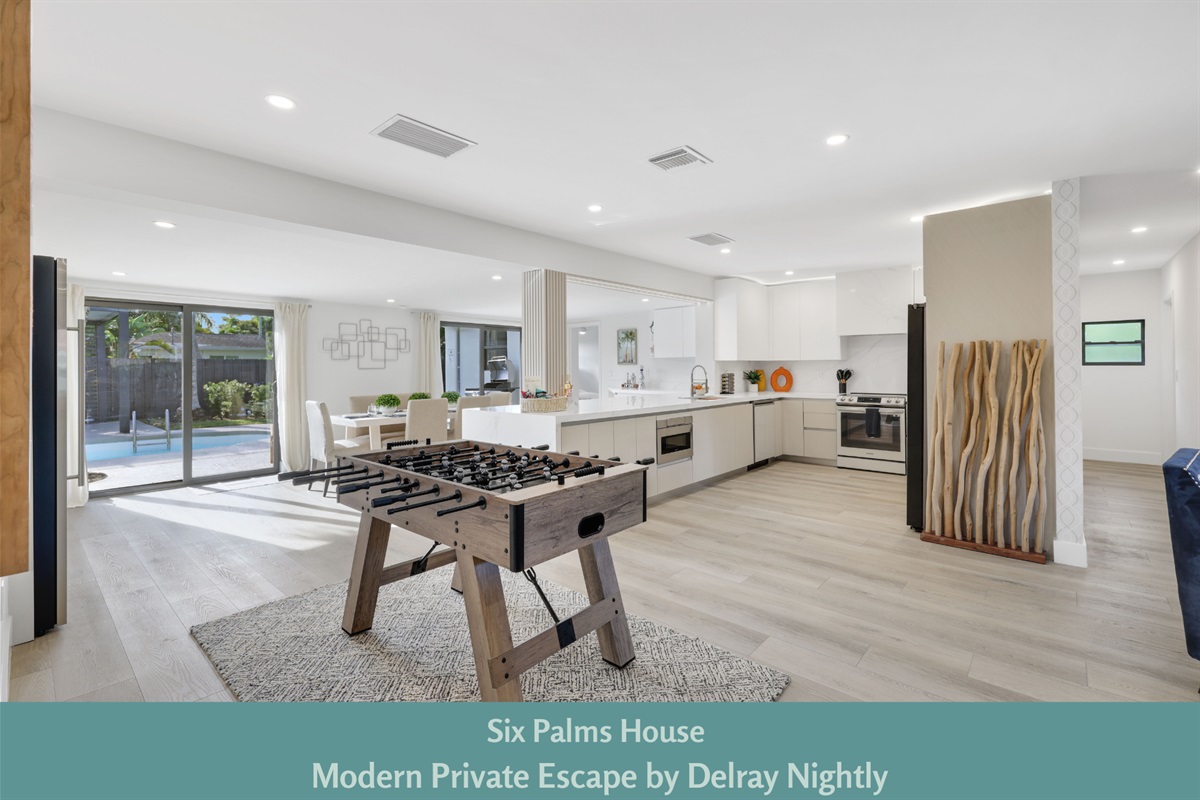 Spacious and modern open-concept villa with a gourmet kitchen, foosball table, and seamless indoor-outdoor living—ideal for your Delray Beach escape.