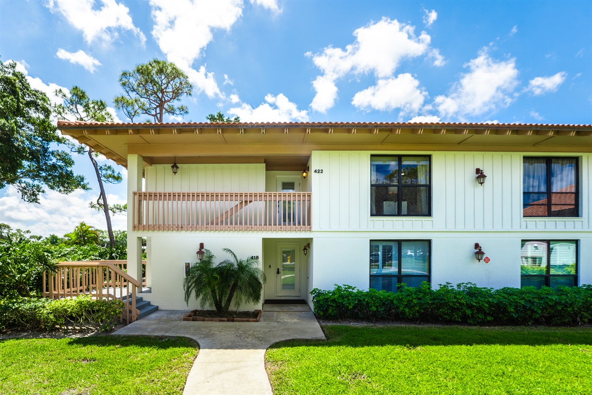 Private entrance surrounded by lush greenery in a quiet, upscale neighborhood