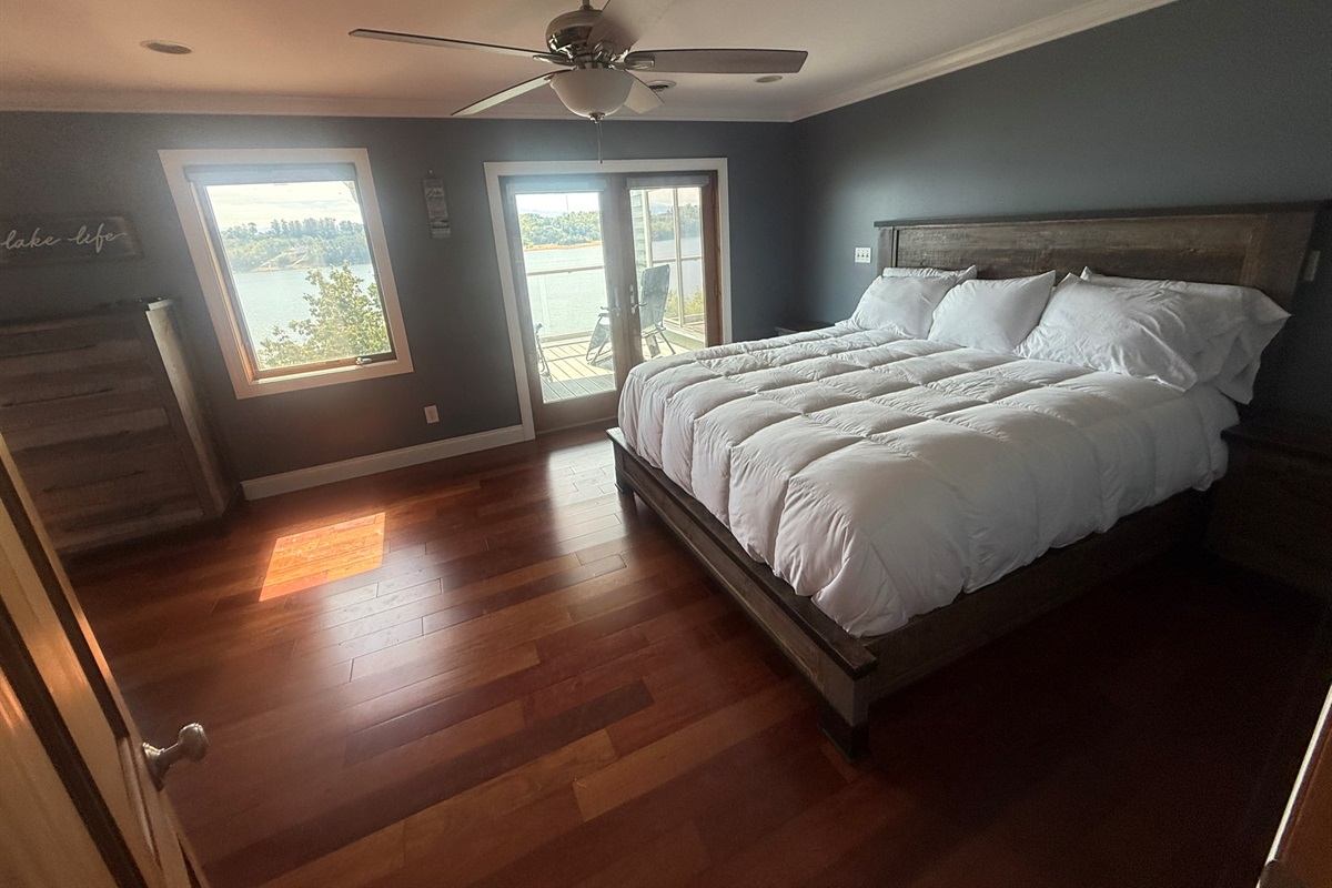 Bedroom 1 with King Bed, private covered porch, and beautiful view of Douglas Lake