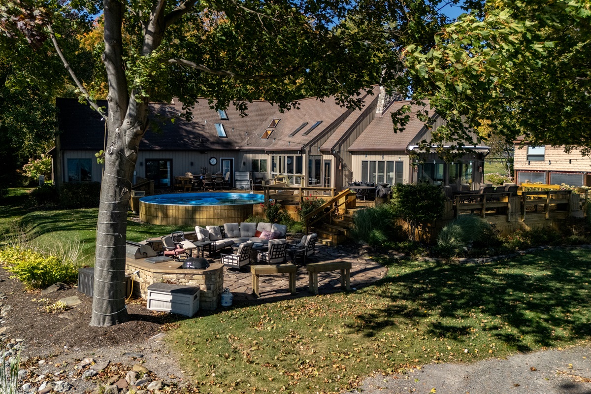 Charming lakeside home with a spacious patio and lush yard for sunny outdoor lounging. A cozy retreat steps from the water.