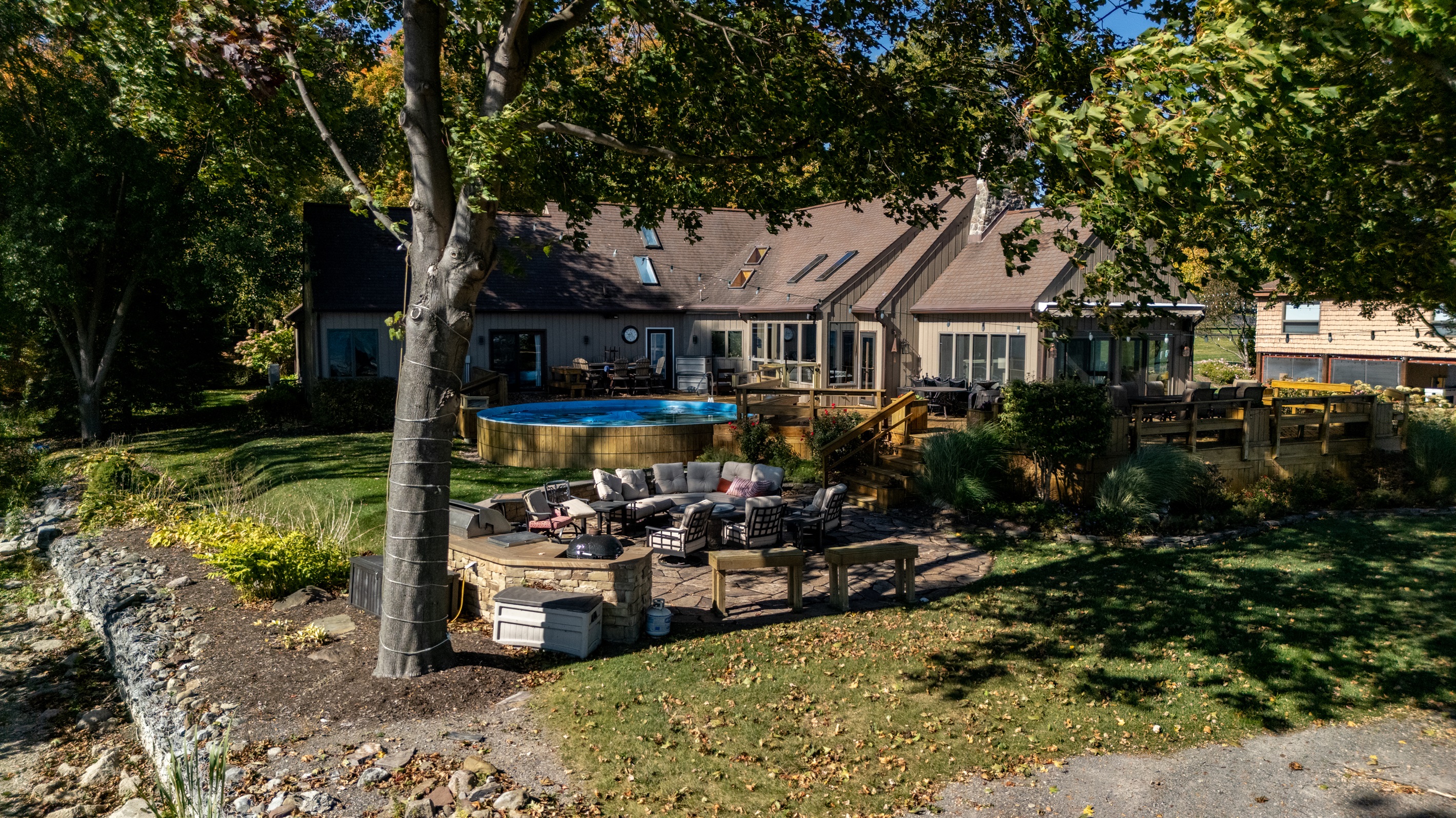 Charming lakeside home with a spacious patio and lush yard for sunny outdoor lounging. A cozy retreat steps from the water.