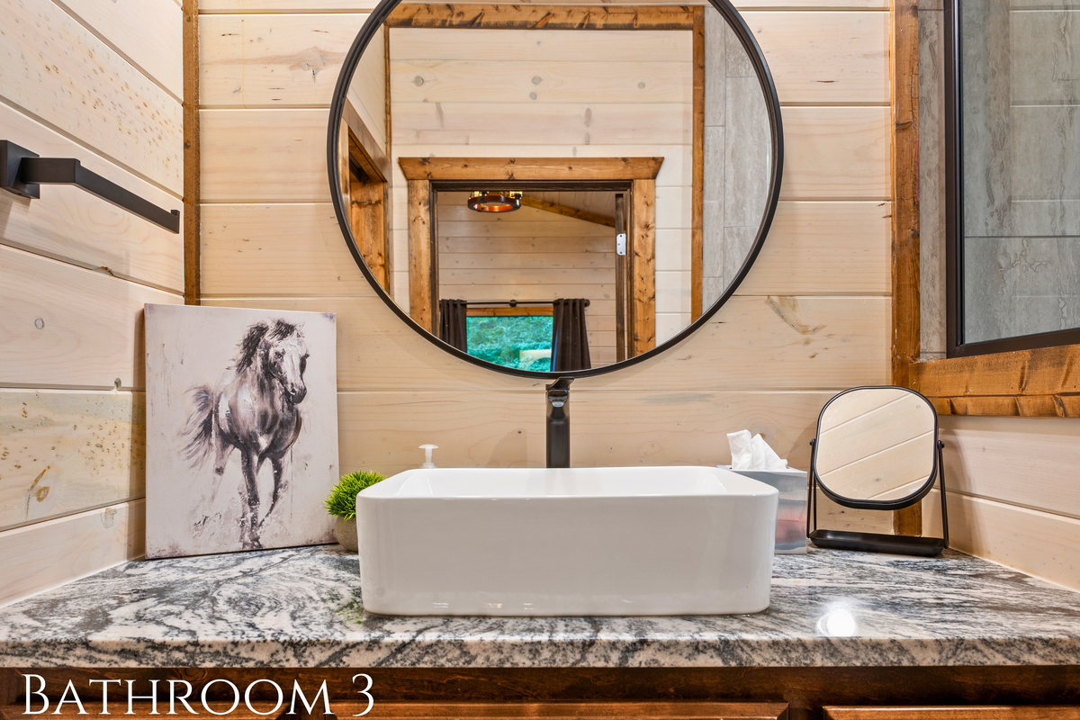 This chic bathroom is modern yet warm, providing a stylish space to freshen up during your stay.