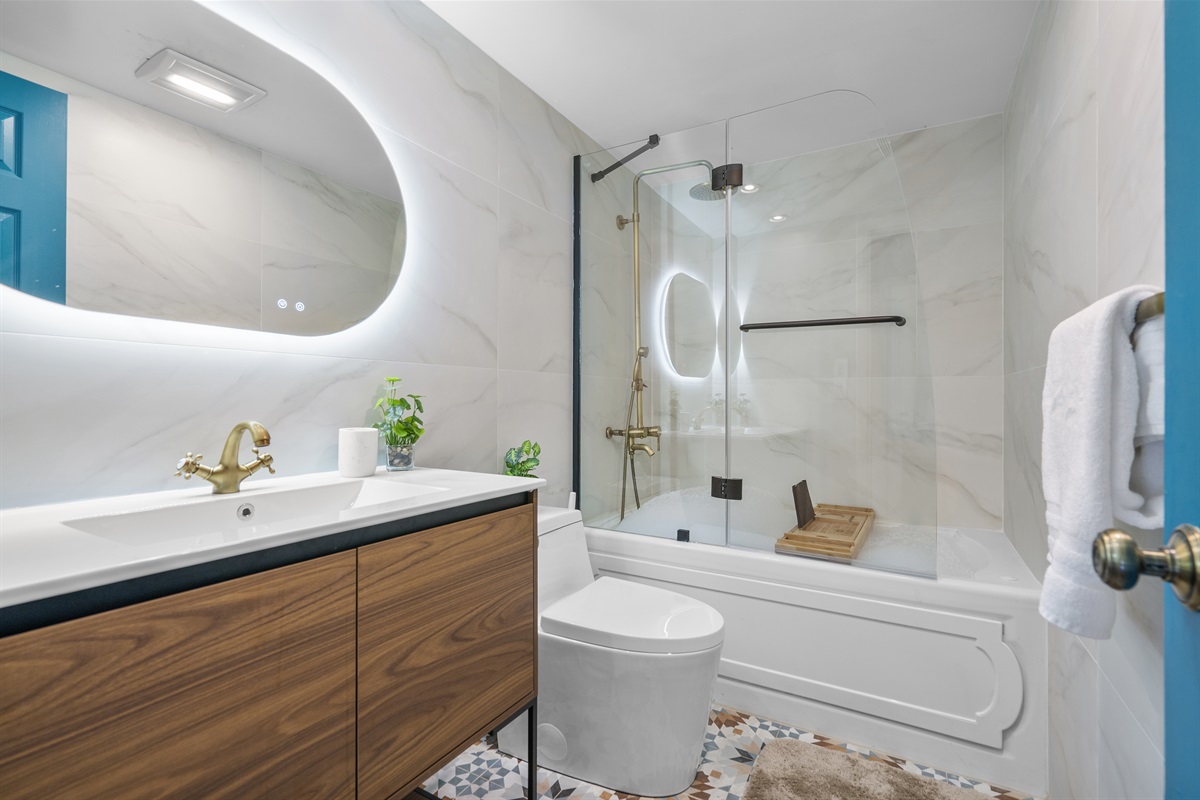 Bathroom with a tub, shower, toilet and sink