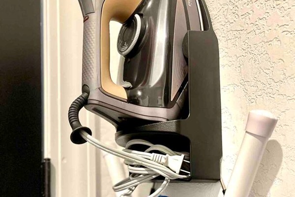 Iron and ironing board located in the laundry room