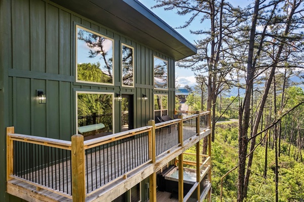 Elevated modern cabin with dual-level outdoor living.