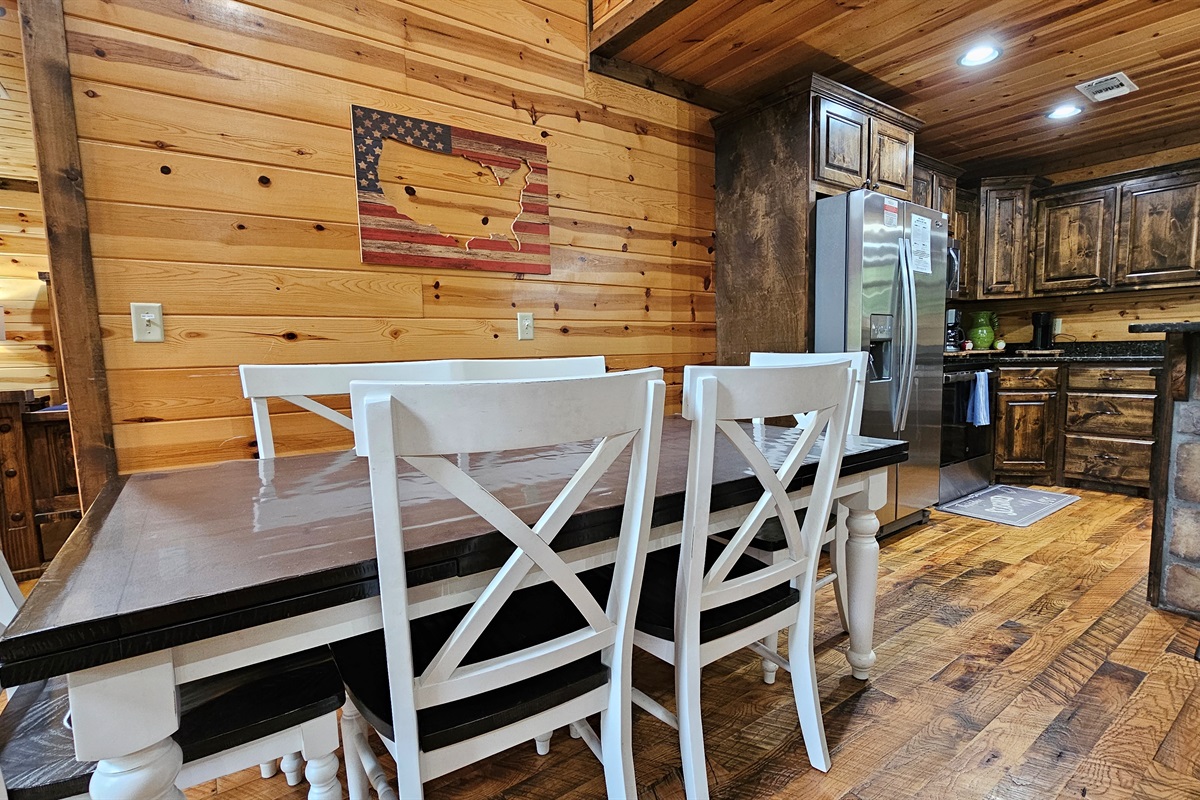 Gather here—rustic charm meets modern amenities in this inviting kitchen-dining space.