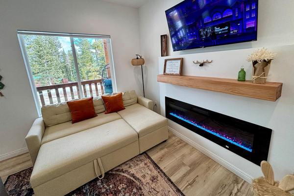 Movie night by the fire hits different here — the sofa pulls out into a comfy bed, perfect for extra guests.