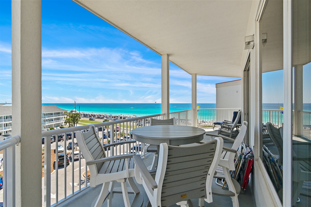 Balcony seating overlooking the sugar‑white sand