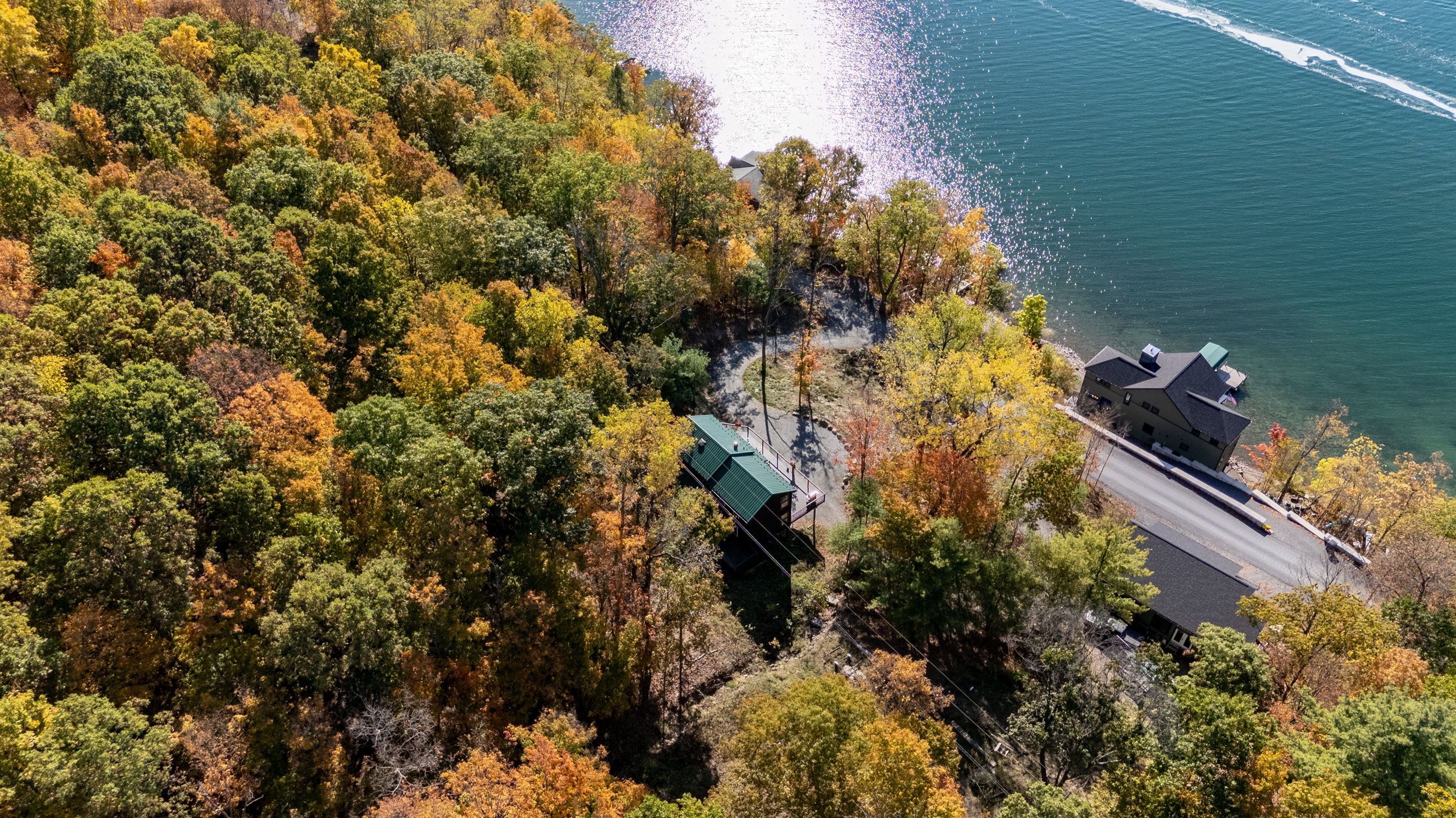 Quiet lakeside access path, shaded by autumn trees, directly to Keuka’s clear waters.