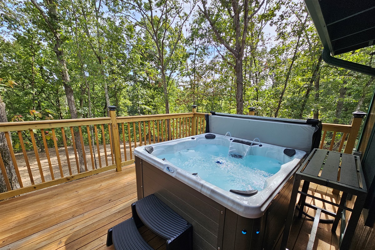 Take a soak in your private hot tub surrounded by trees — the ultimate way to relax in nature.