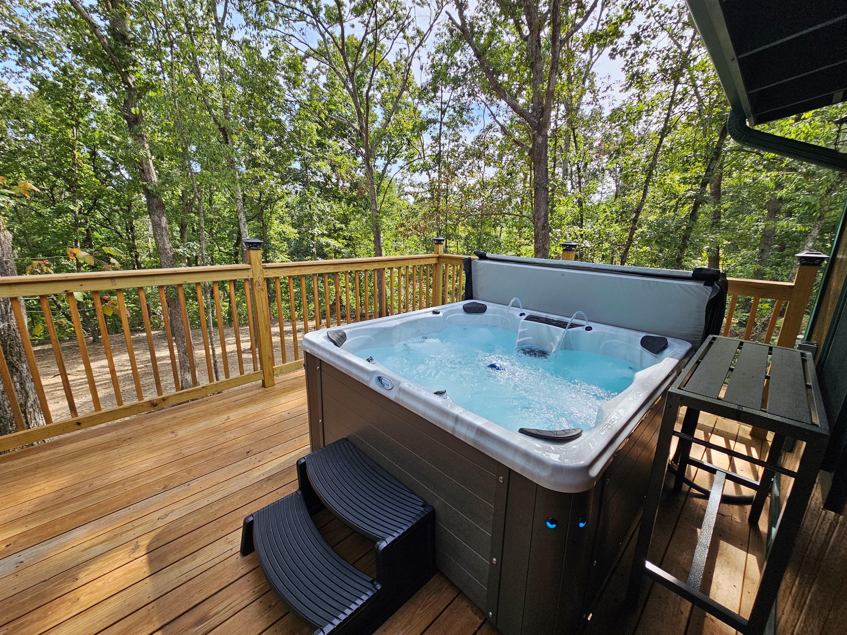Take a soak in your private hot tub surrounded by trees — the ultimate way to relax in nature.