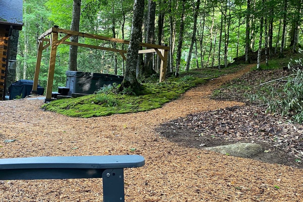 The path leads to a large rock formation on the property 