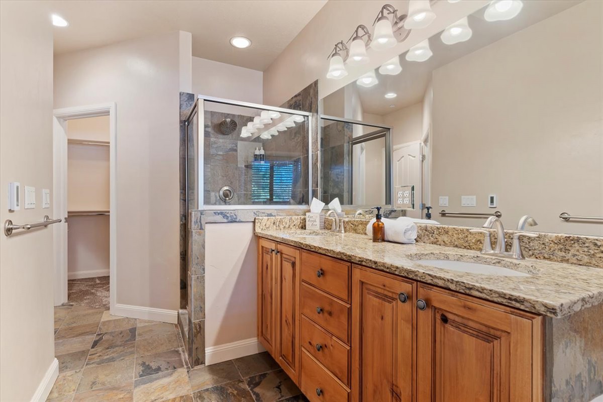 A spacious upstairs primary ensuite featuring dual vanities, granite countertops, and refined finishes—designed for a spa-like start and end to your day.
