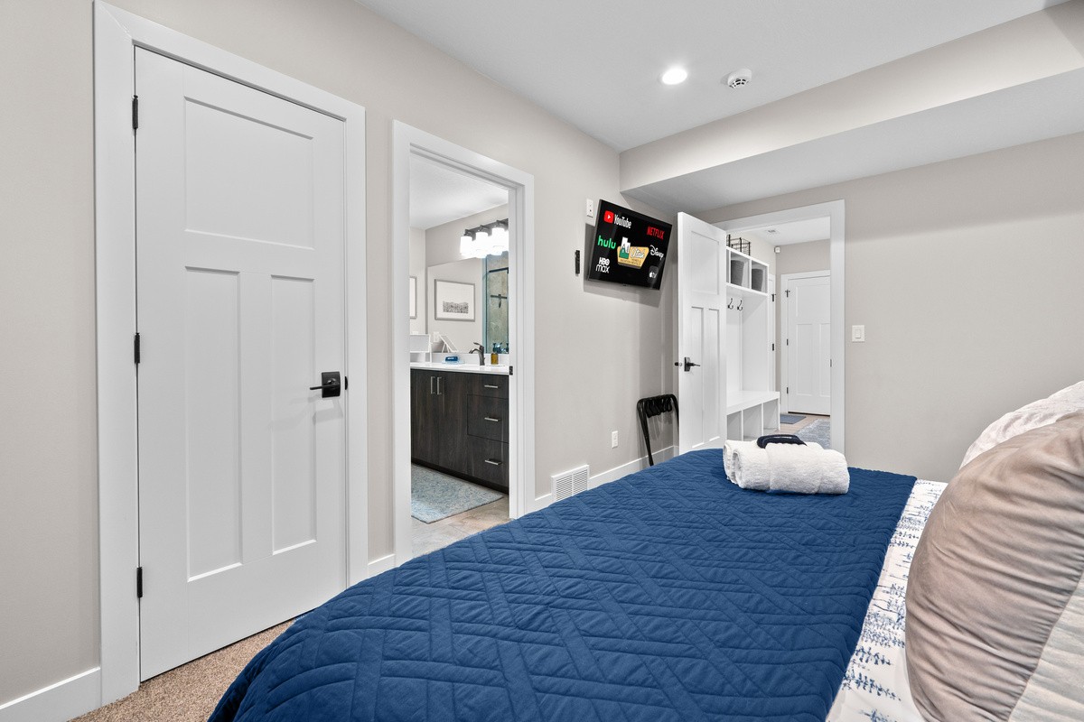 Spacious lower-level king bedroom with a Smart TV and convenient access to the adjacent full bathroom.