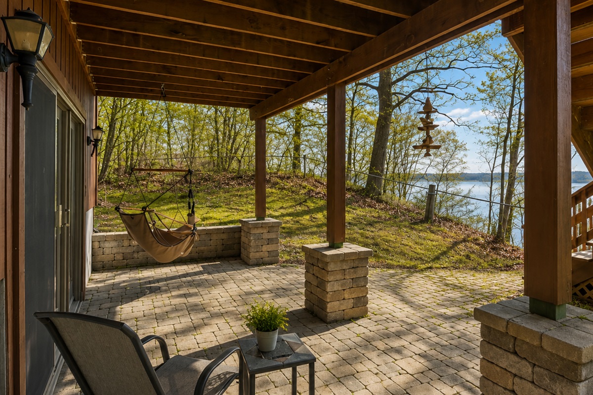 Porch 2 (directly outside of bedroom 4 on the first floor) - Unwind in this sheltered patio area, complete with a hammock and seating, nestled among the trees with a view of the lake. Ideal for tranquil relaxation. 