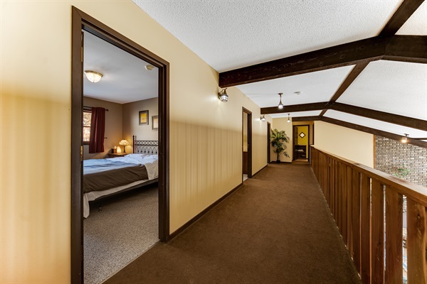 The upper balcony and upper three bedrooms. Two bathrooms are at the end of the hallway.
