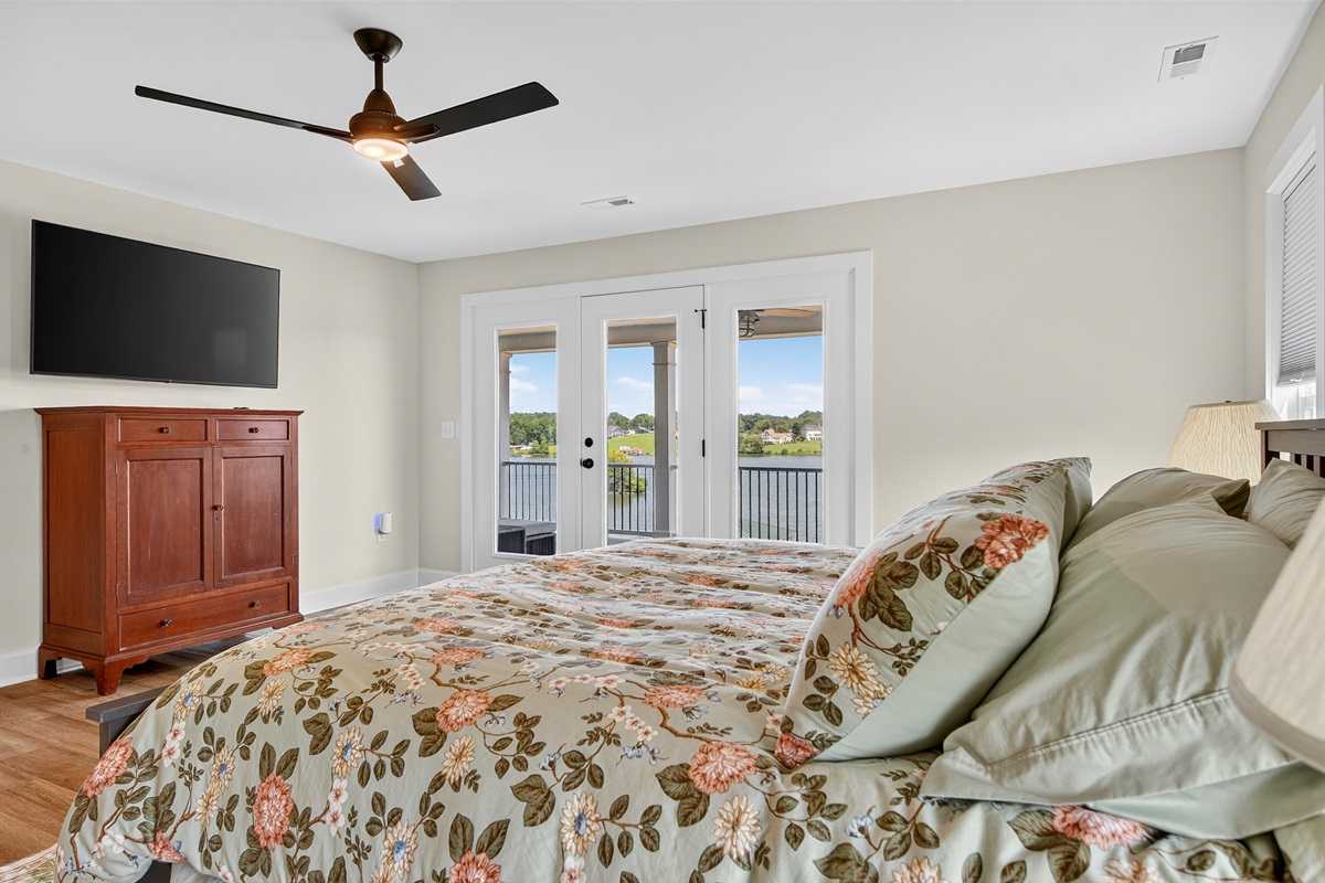 Stretch out and unwind in this serene king suite featuring a plush bed, private sitting area, and direct access to the wraparound porch.