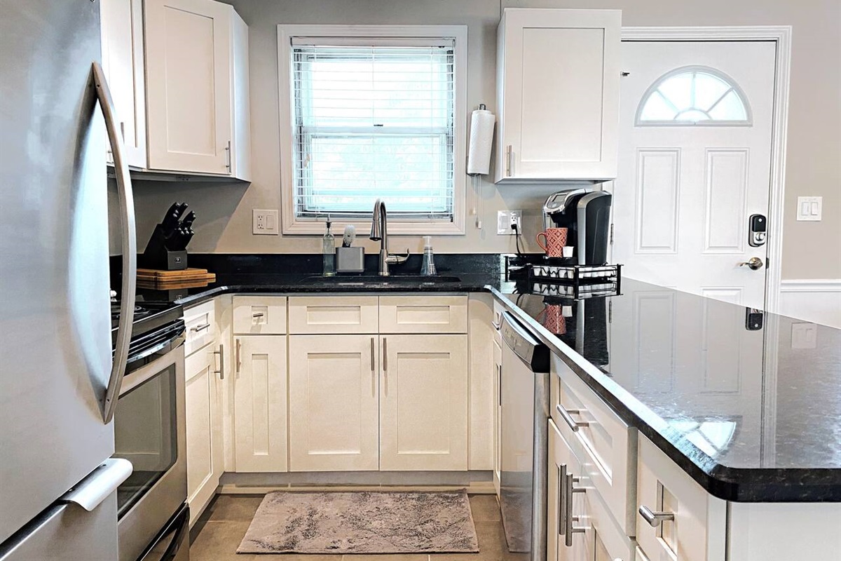 Fully equipped kitchen with overhang bar for easy serving and brand new stainless appliances!