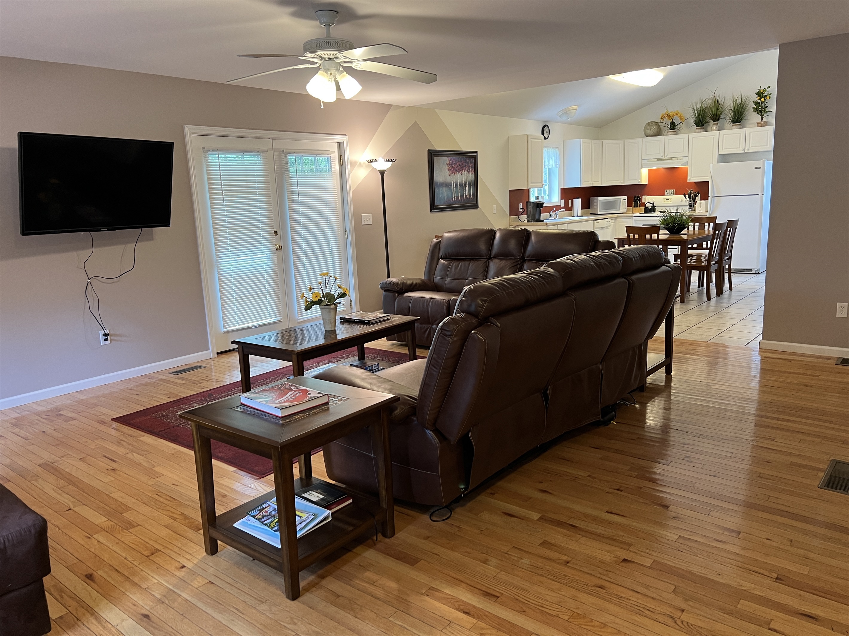 The Federal House Apartment 1 living room looking into the kitchen area , French doors leading to large side yard.
